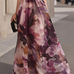 Purple floral maxi dress with belted waist and full flowing skirt, side view