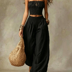 Smocked crop top and wide-leg pants set in black, ruched crop top and relaxed wide-leg fit.