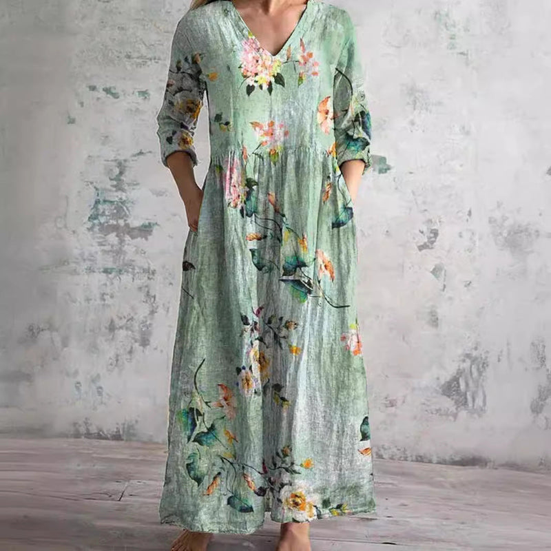 Green floral summer dress with V-neck, three-quarter sleeves, and relaxed maxi fit