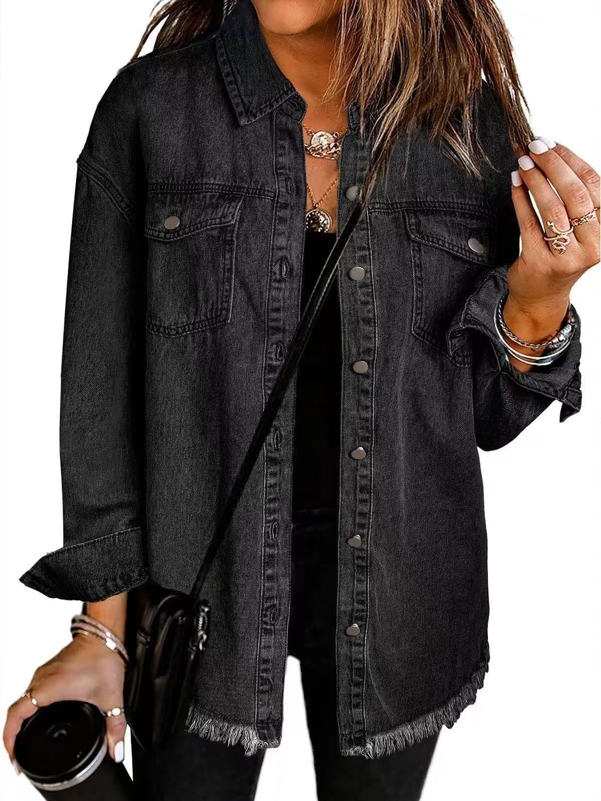 Black denim jacket with button front, chest pockets, and frayed hem.