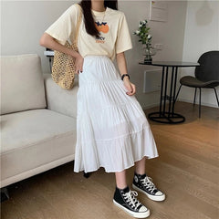 White tiered A-line midi skirt with elastic waist, flowing ruffle tiers