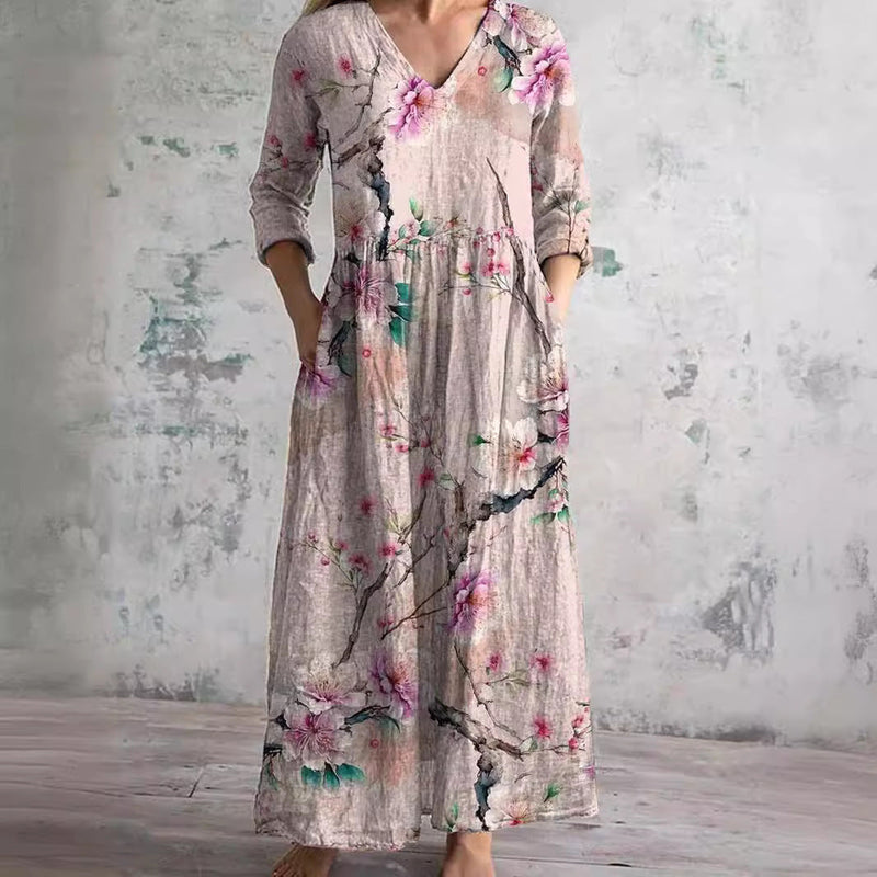 Pink floral summer dress with V-neck, long sleeves, gathered waist and tiered skirt