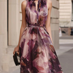 Purple floral sleeveless maxi dress with tie-neck detail and belted waist, upper body
