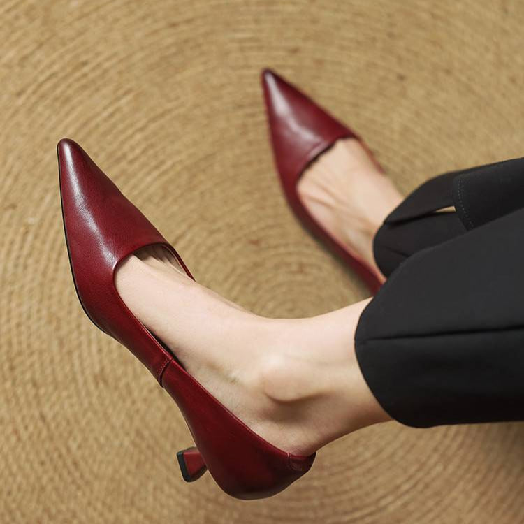 Red leather pointed-toe pumps with low heel and slim back strap detail