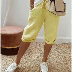 Lightweight summer shorts in yellow, rolled hem, drawstring waist and side pockets.