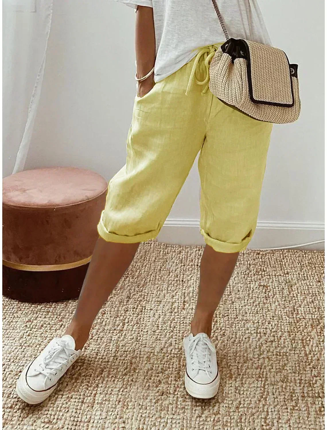 Lightweight summer shorts in yellow, rolled hem, drawstring waist and side pockets.