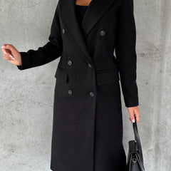 Black longline double-breasted coat with notched lapels and flap pockets