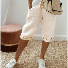 Lightweight summer shorts in off-white, rolled hem, drawstring waist and side pockets.