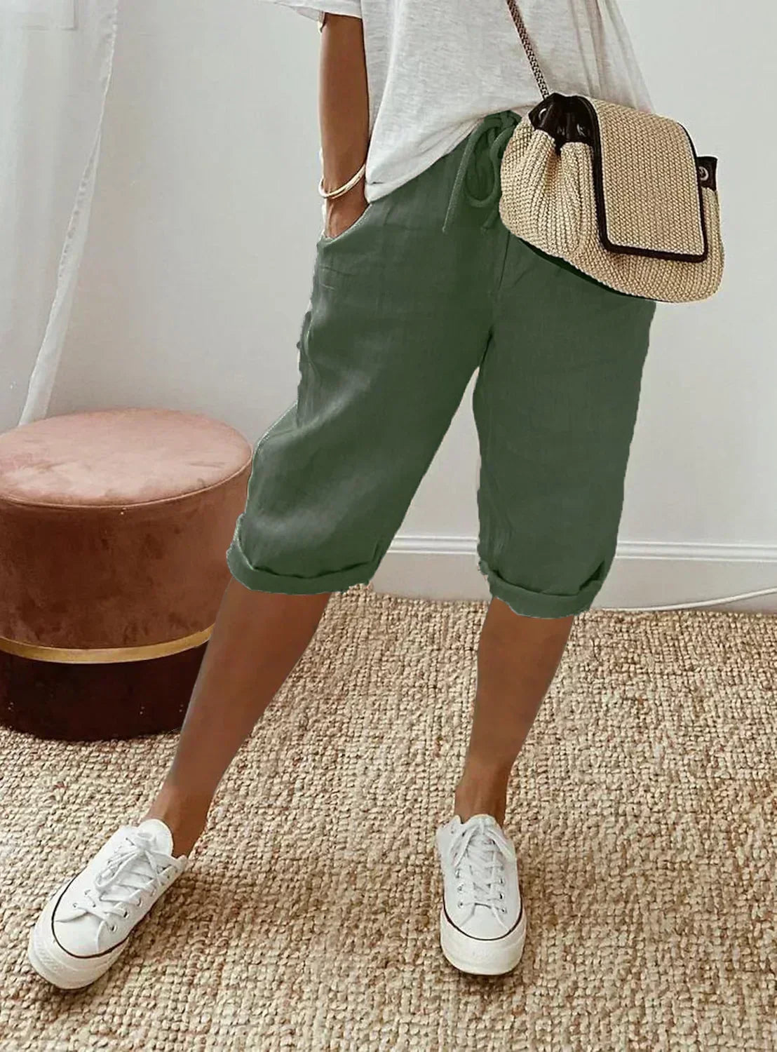 Lightweight summer shorts in dark green, rolled hem, drawstring waist and side pockets.