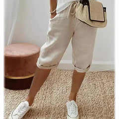 Lightweight summer shorts in cream, rolled hem, drawstring waist and side pockets.