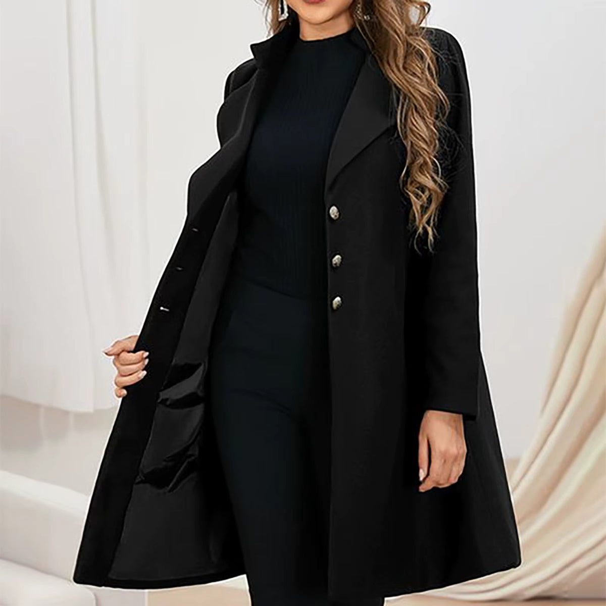 Women’s long black coat with notched lapels and button closure