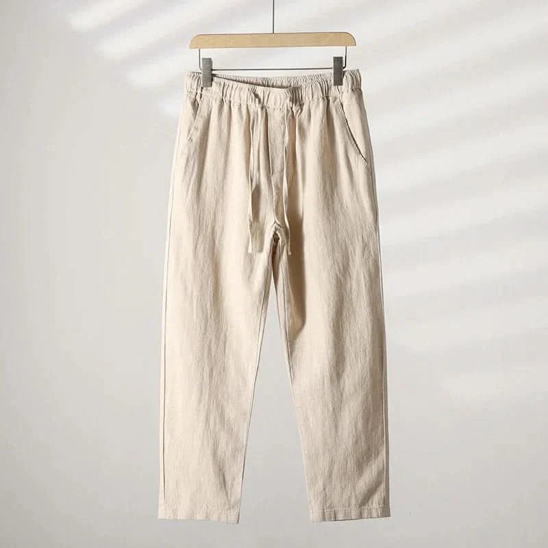 White linen pants with elastic waistband and drawstring, relaxed straight-leg fit
