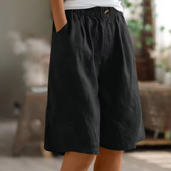 Relaxed summer shorts in black, elastic waistband and front button, knee length.