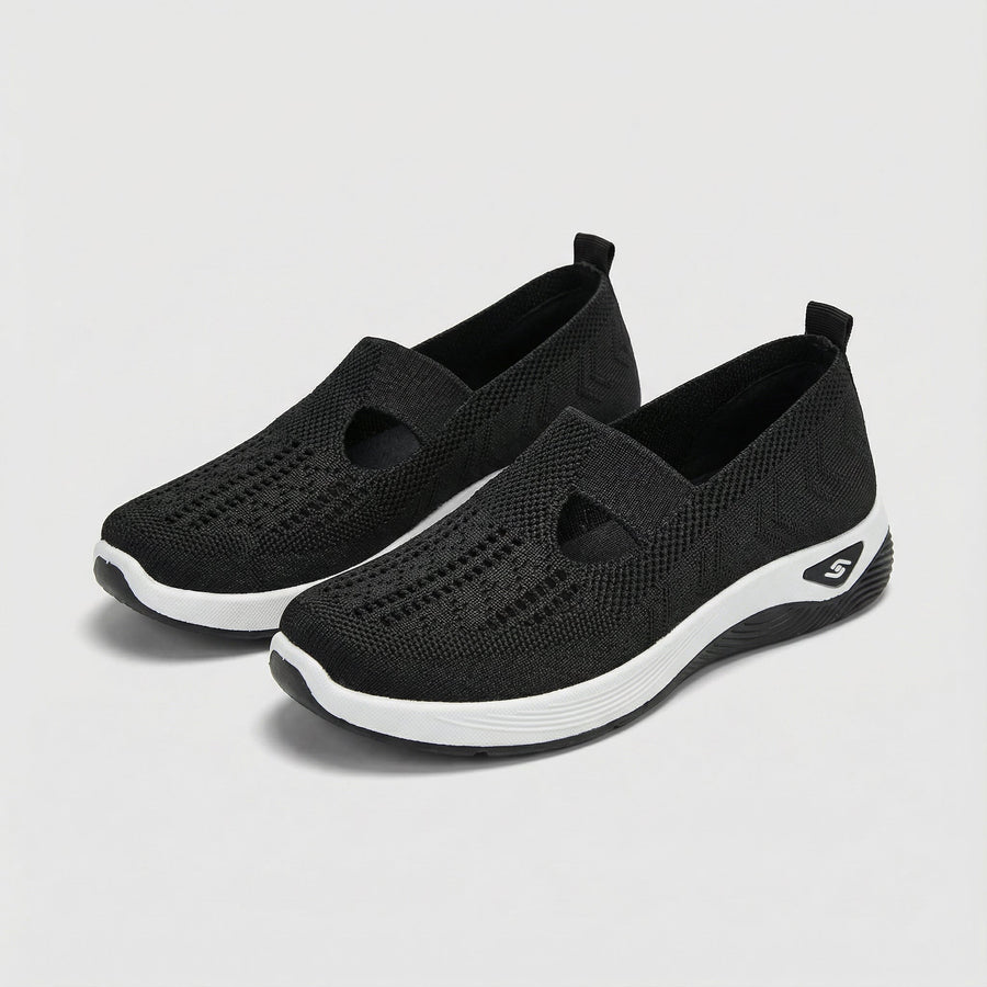 Black slip-on orthopedic shoes with knit upper, cushioned collar and round toe