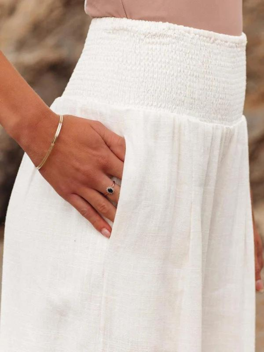 White wide-leg trousers with shirred waist and textured woven fabric