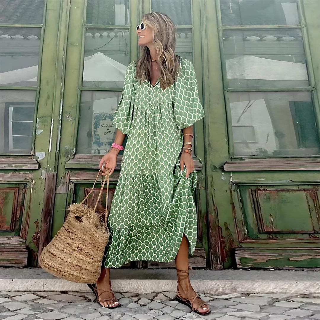 Green boho maxi dress with white repeating pattern, V-neck with flowing fit and slits