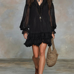 Black ruffle-trim mini dress with sheer puff sleeves and tiered skirt.