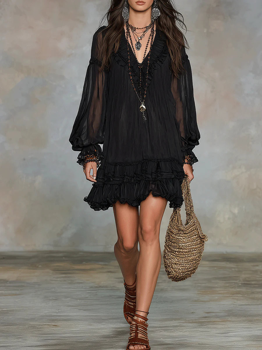 Black ruffle-trim mini dress with sheer puff sleeves and tiered skirt.