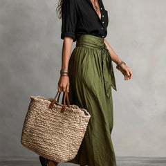 Black blouse top and olive green midi skirt two-piece set, side view with tote