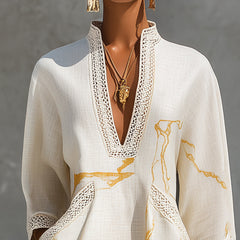 Ivory V-neck midi dress with ornate lace trim and gold marble pattern