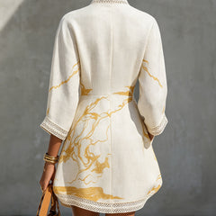 Back of ivory midi dress with V-shaped lace detail and gold abstract print