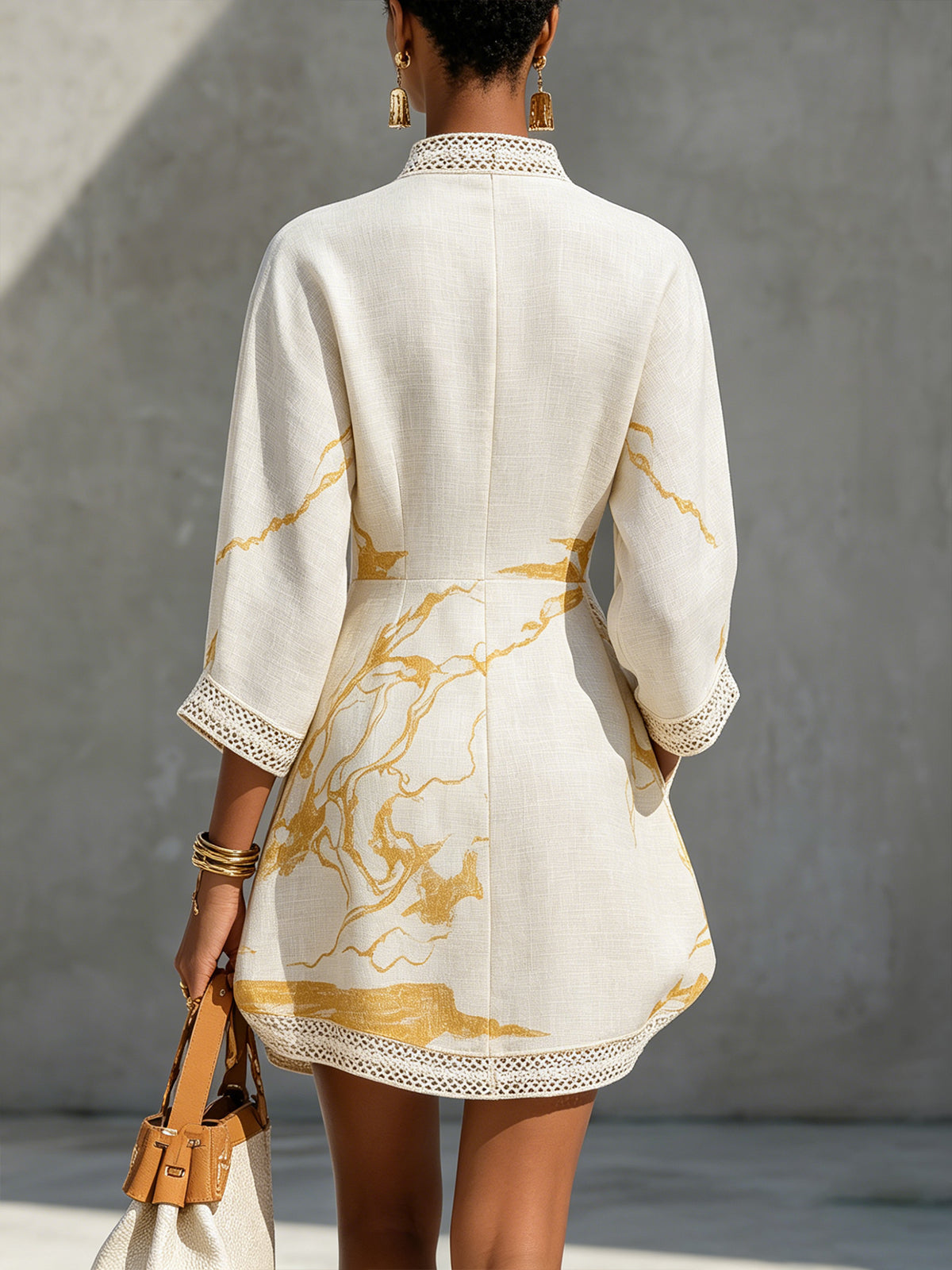 Ivory lace midi dress back view with gold abstract print and lace-trim hem