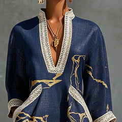 Navy midi lace-trim dress with gold print and deep V neckline; close-up