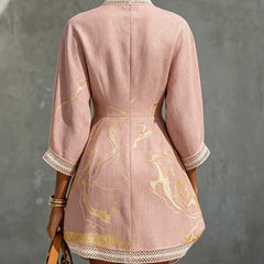 Back view of pink midi dress with gold pattern, V-back opening, lace cuffs and hem