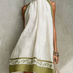 White halter midi dress with high neckline and green floral hem border