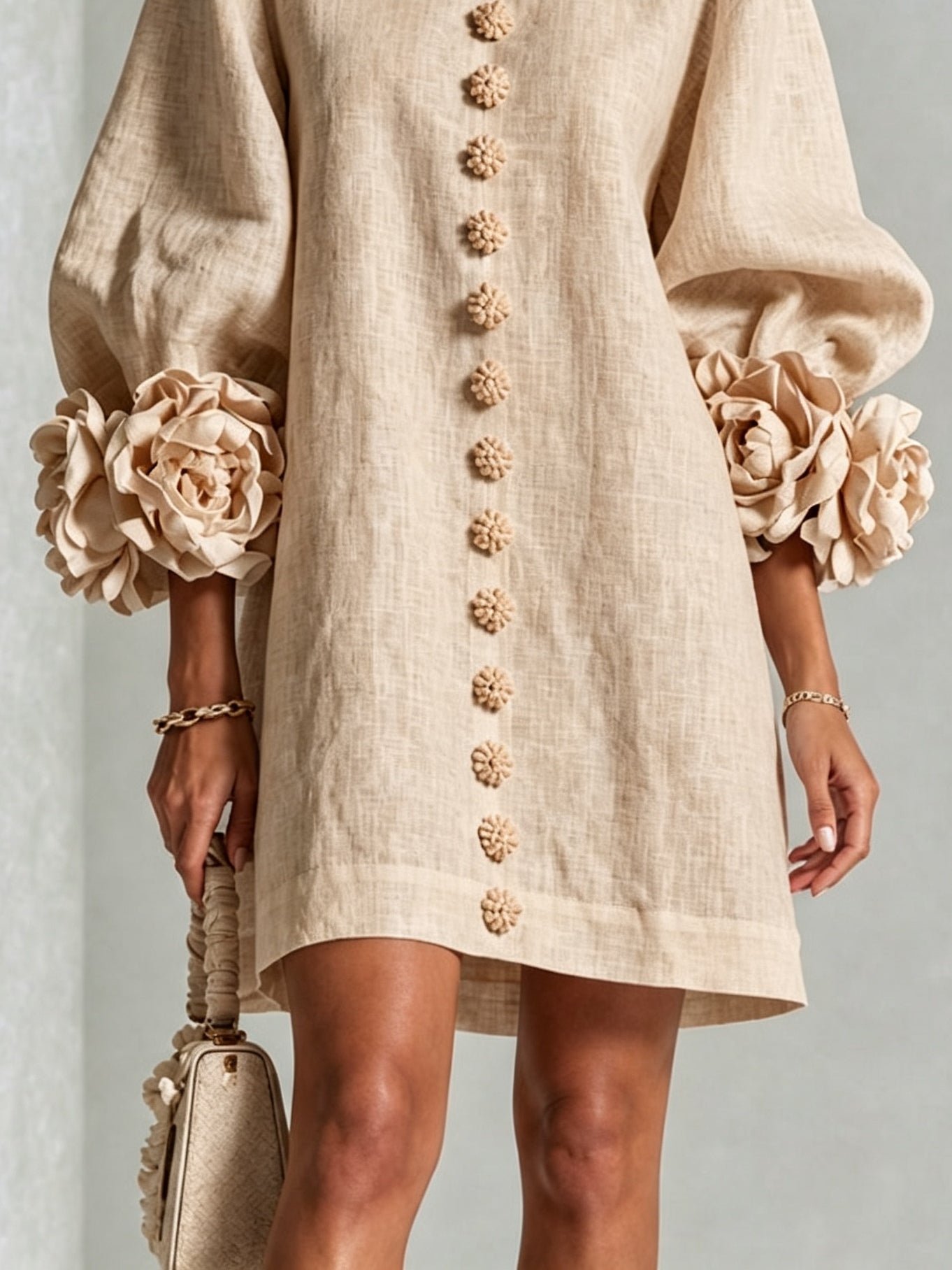 Beige button-front midi dress lower detail with floral buttons and straight hem