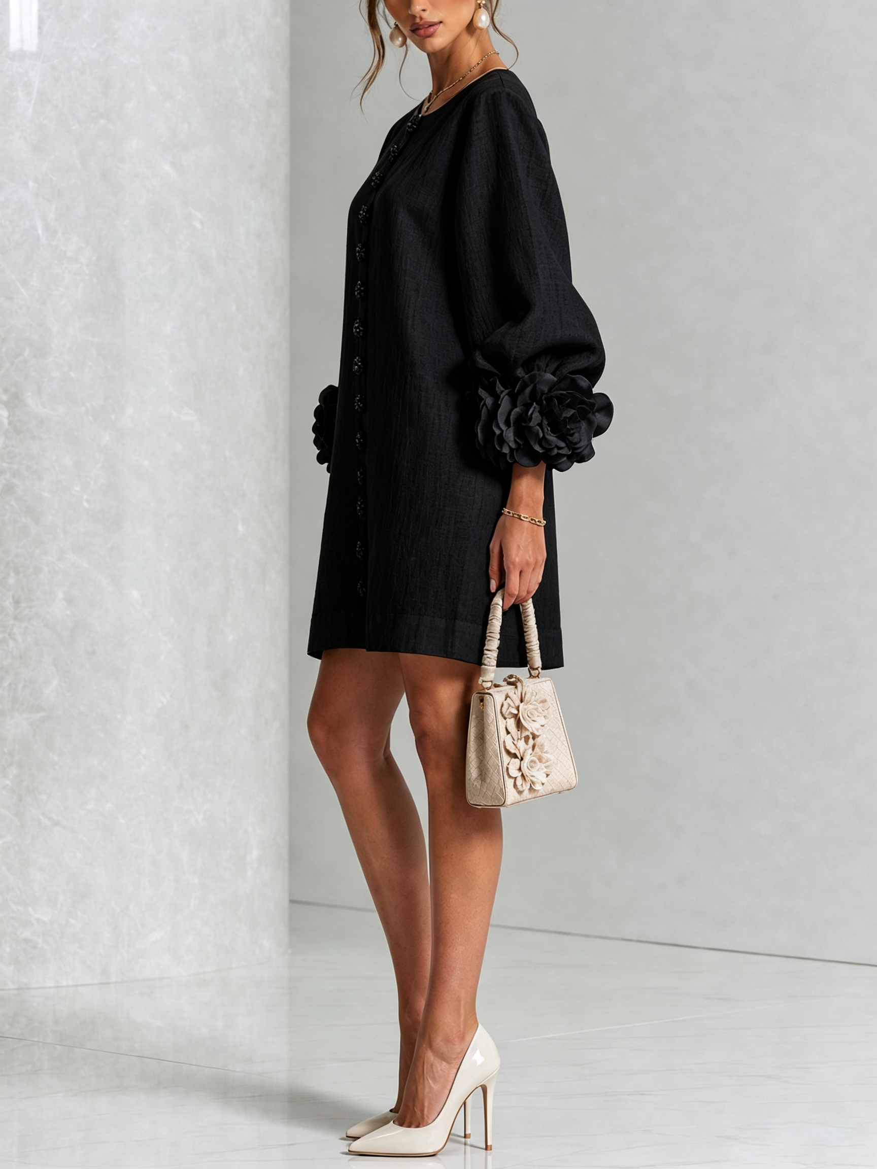 Black button-front midi dress with long sleeves and oversized rosette cuff accents