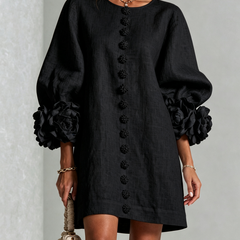 Black button-front midi dress with floral front detail and puff sleeves, rosette cuff