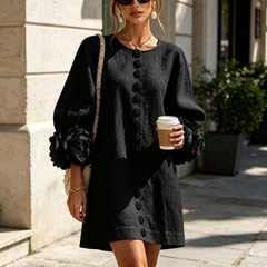 Black button-front midi dress with rosette cuffs and long sleeves, front view