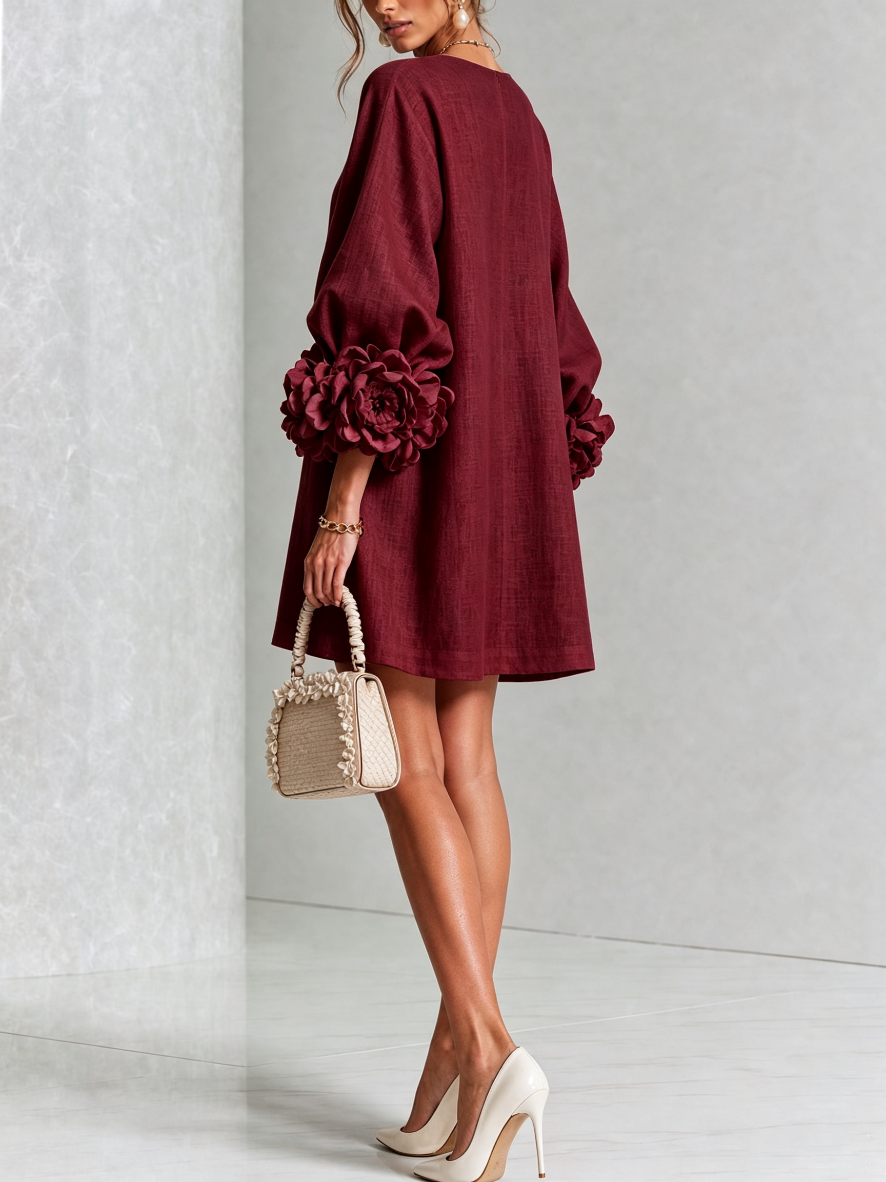 Burgundy linen midi dress with long sleeves, rosette cuffs, and V-back neckline detail