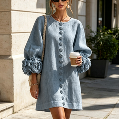 Light blue button-front midi dress with vertical button placket and rosette cuff details