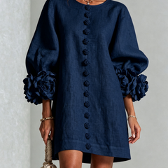 Dark navy button-front midi dress with long sleeves and rosette cuff detail