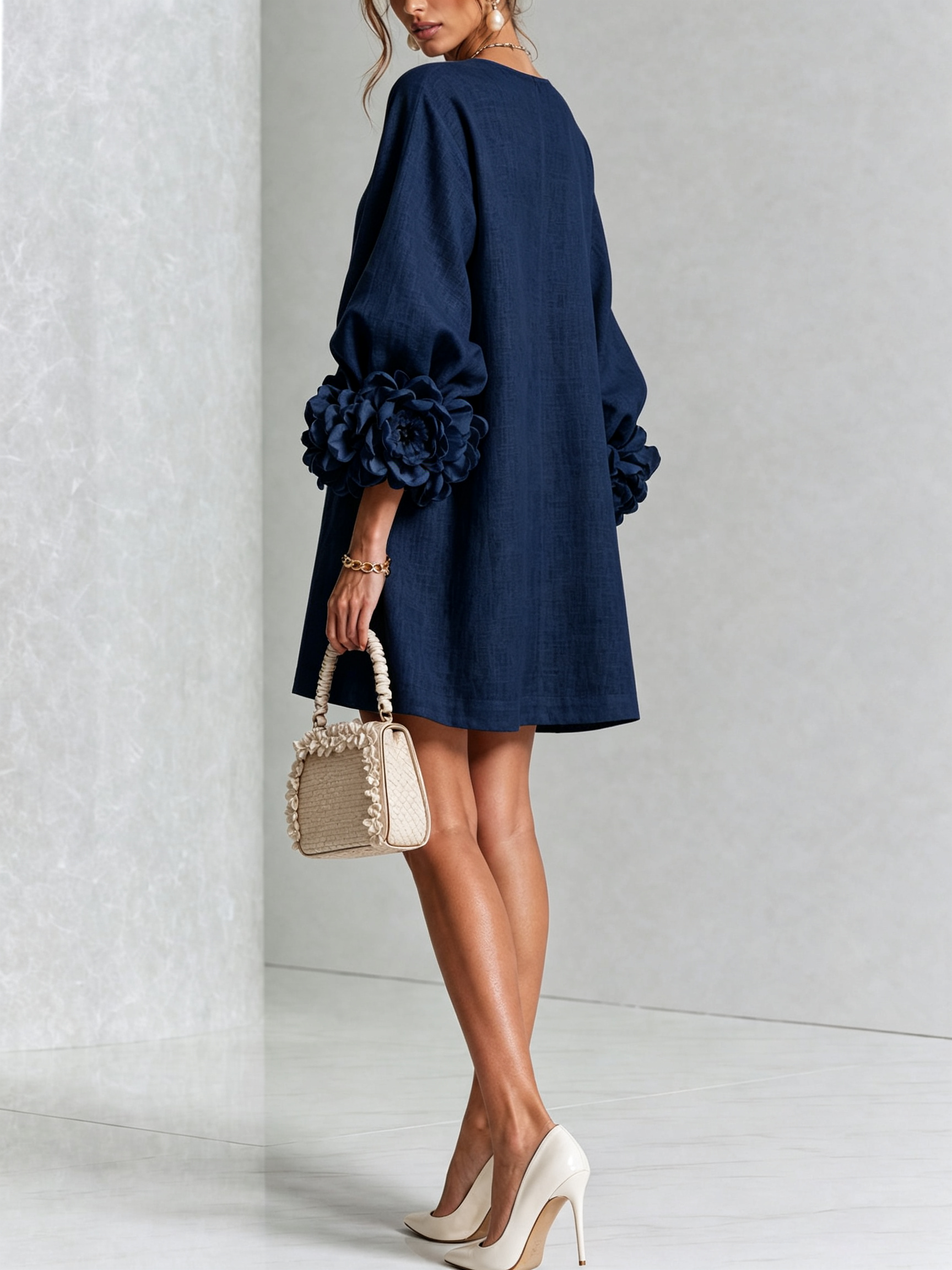 Navy embroidered midi dress, angled view with puff sleeves and rose rosette cuff details