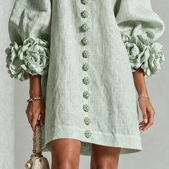 Sage green midi dress with rosette puff sleeves and vertical floral embroidery placket
