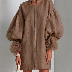 Brown midi dress with front zipper and voluminous balloon sleeves with ruffled cuffs.
