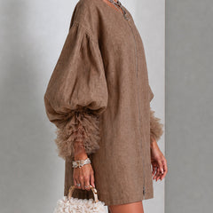 Brown zip-front midi dress with oversized balloon sleeves and layered ruffle cuff detail.