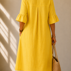 Yellow back view midi dress with pleated yoke and three-quarter bell sleeves