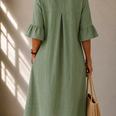 Back of sage green midi dress with pleated yoke and gathered bell sleeves