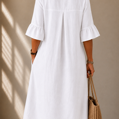 White button-back dress with gathered bell sleeves and central back seam