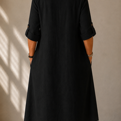 Black midi dress back view with elbow-length sleeves and gathered cuffs