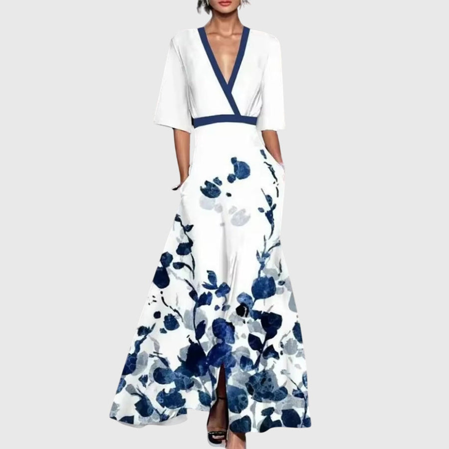 White floral spring dress with navy V-neck, short sleeves, and waist tie belt