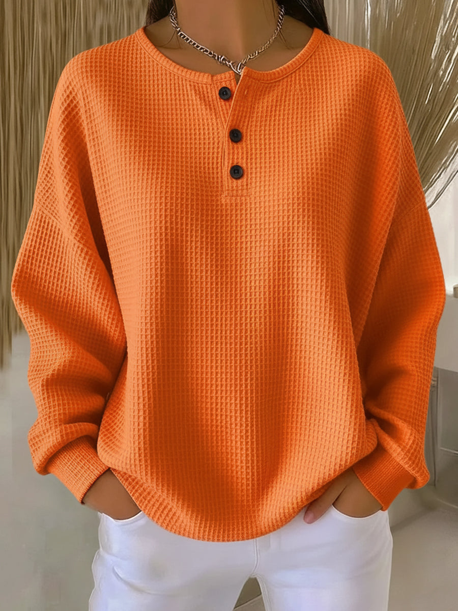 Orange waffle henley sweatshirt with buttoned placket and long sleeves