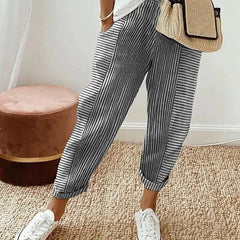 Classic striped trousers, dark with white vertical stripes and cuffed hems