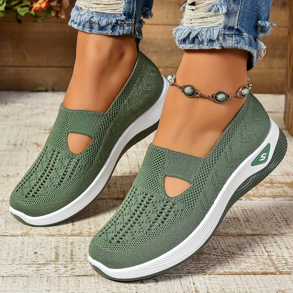 Green knit slip-on shoes with side cutouts and white sole