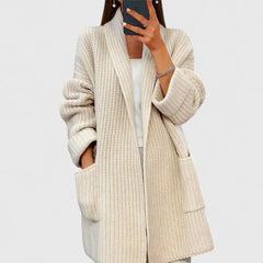Beige chunky knit cardigan with shawl collar, open front, and patch pockets