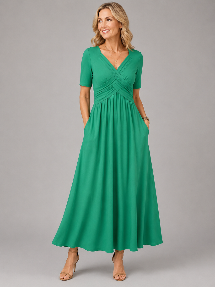 Green midi dress with V-neck, short sleeves, cross-over bodice, and gathered skirt